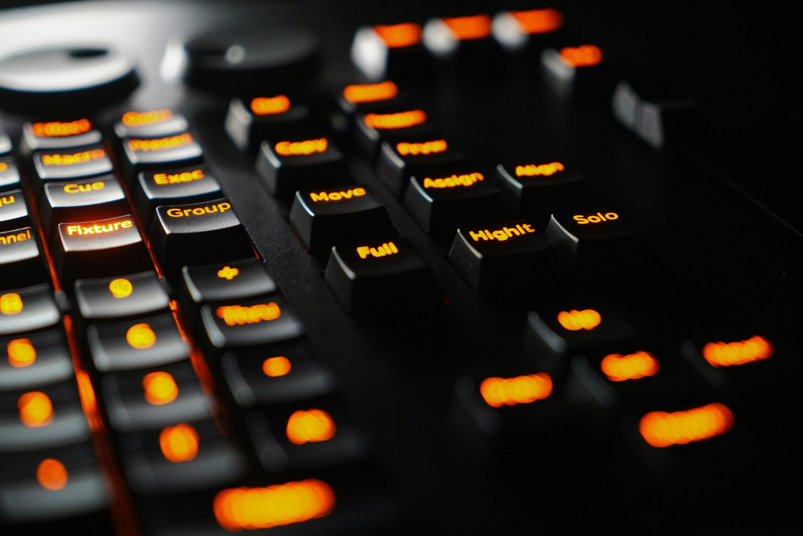 a close up of a black keyboard with orange keys